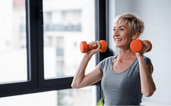 Smiling woman exercising with weights