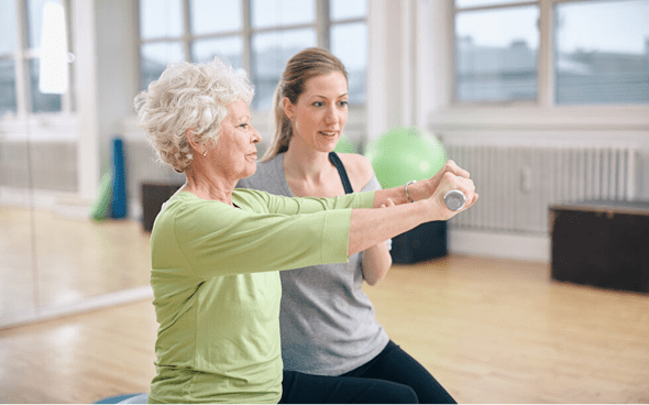 Personal training session for elderly woman