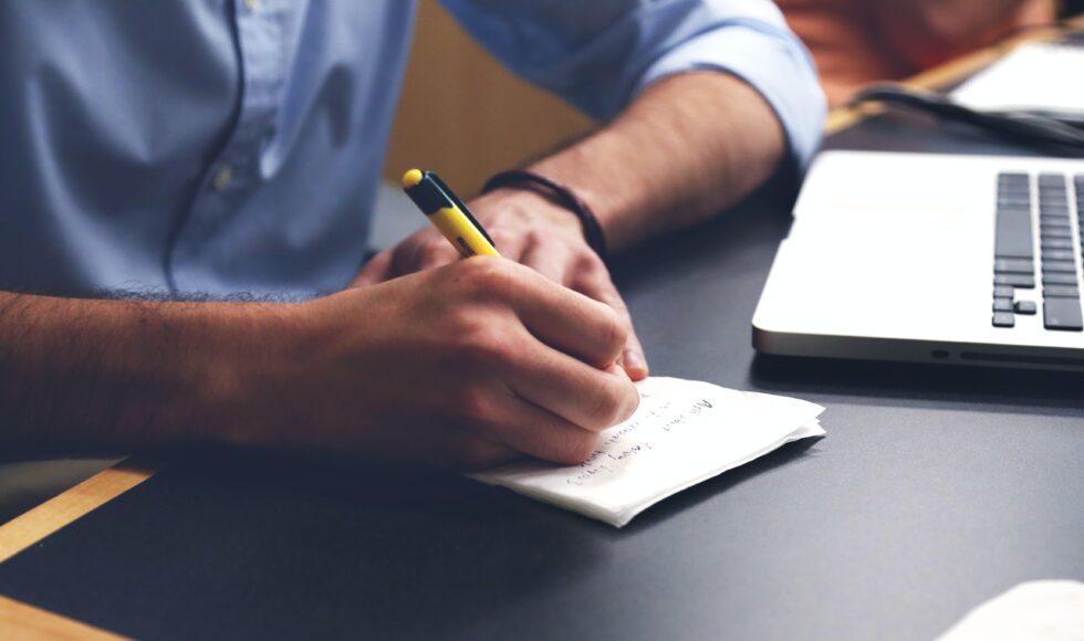 Handwriting on paper near a computer
