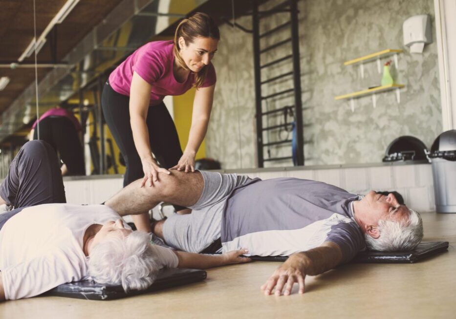 Seniors in a stretching class with trainer