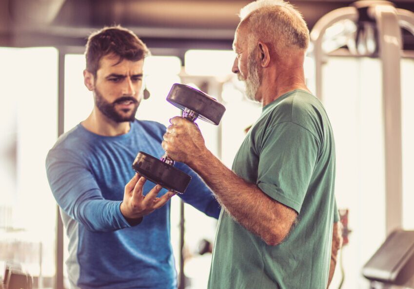 Gym workout with personal trainer