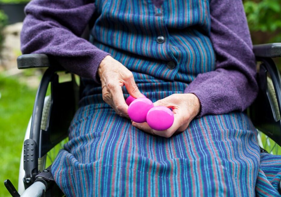 Senior sitting with stress balls outdoors