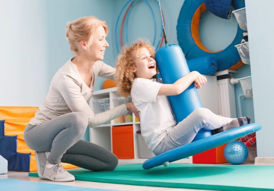 Child enjoying indoor swing therapy