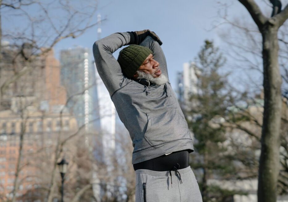 Man stretching outdoors in winter clothing