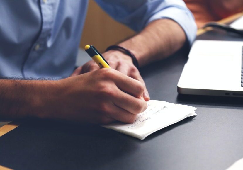 Handwriting on paper near a computer