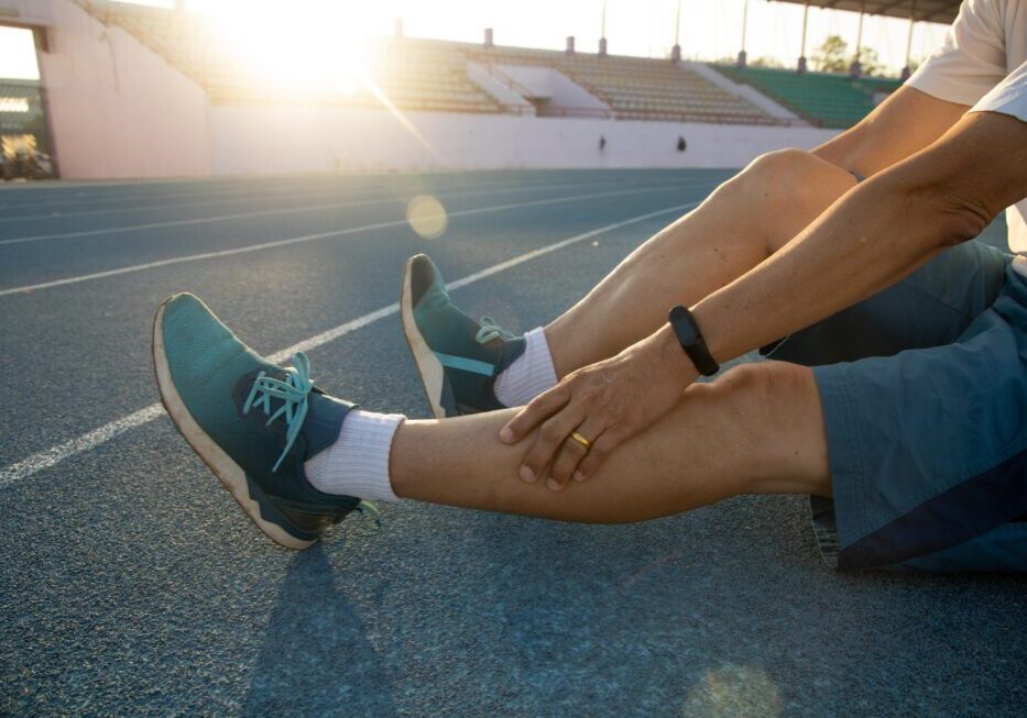 Athlete resting on track at sunrise