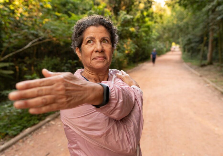 Woman stretching on a forest path