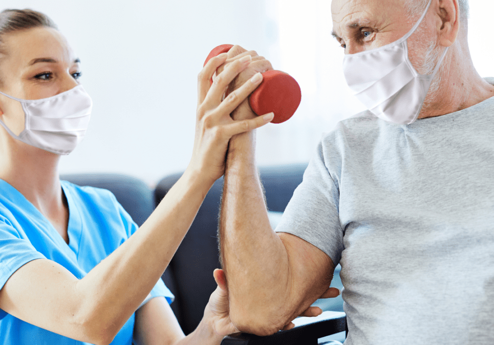 Physiotherapist helping senior with exercise